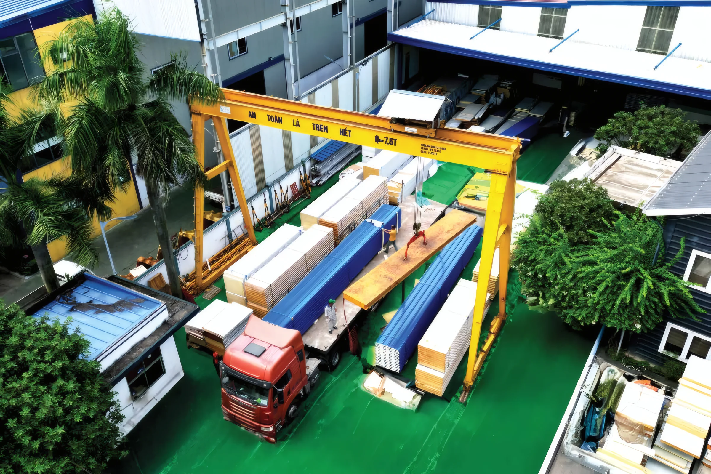 An overhead crane handling panels in the workshop
